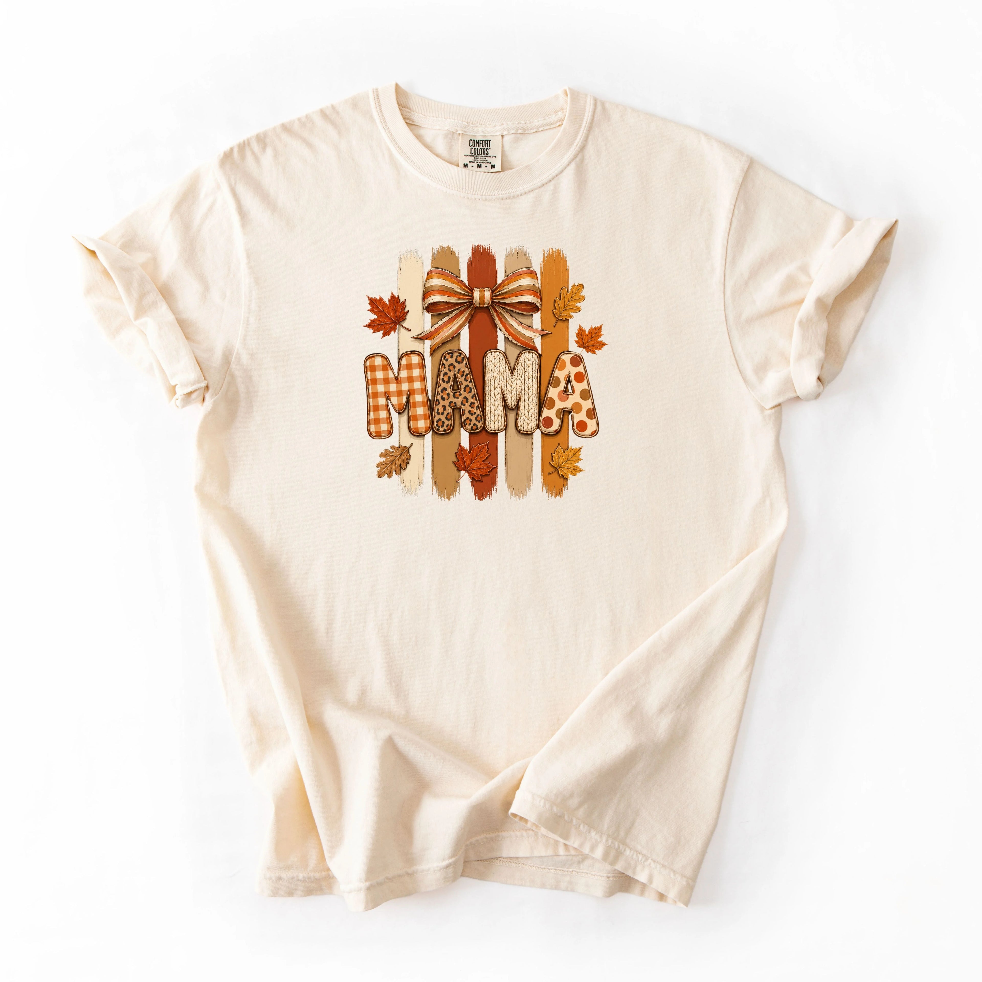 Ivory Comfort Colors long sleeve tee with MAMA fall leaves bow patterned letters in buffalo plaid, leopard, and polka dot with brushstroke background