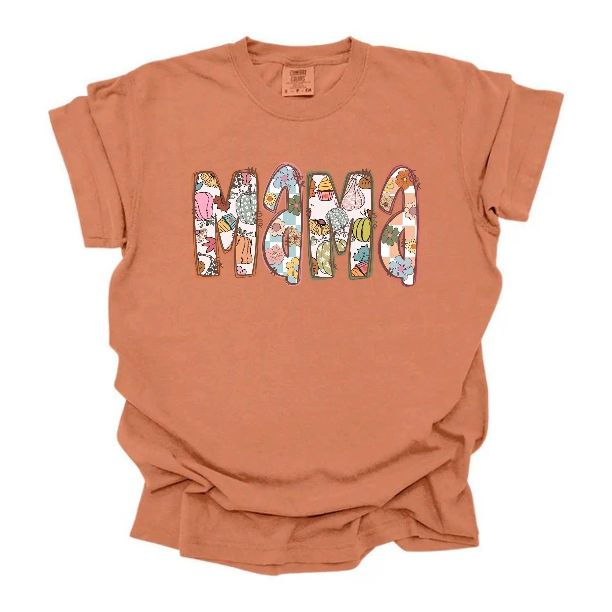 Terracotta Comfort Colors tee with MAMA spelled out in boho fall patterned letters featuring florals, pumpkins, leopard, and cupcake motifs