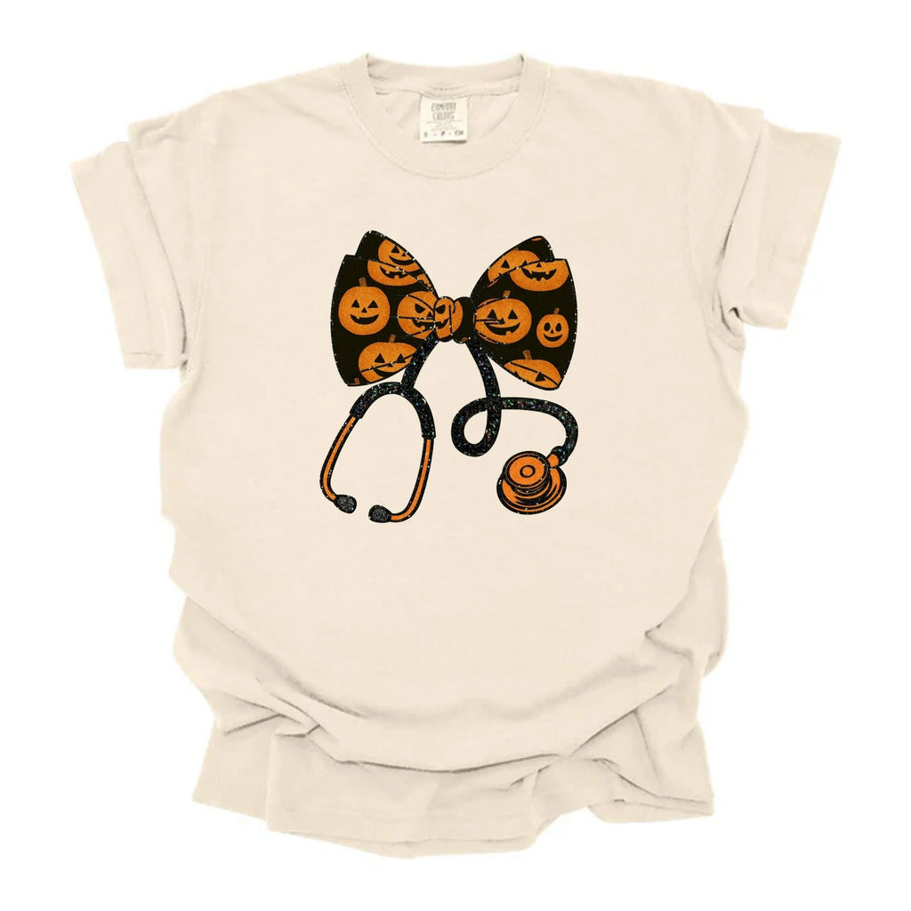 Halloween Nurse Pumpkin Bow Stethoscope Graphic Tee on natural colored shirt