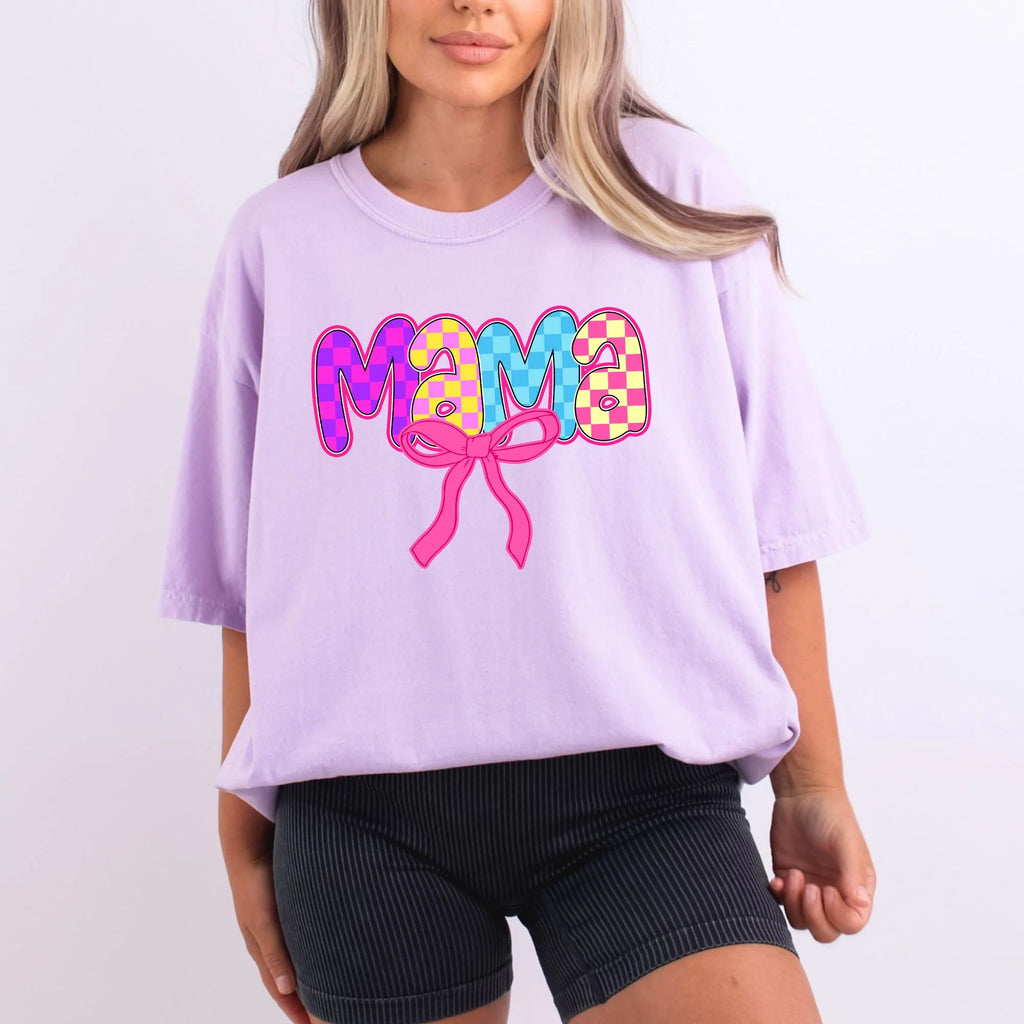 Lavender Comfort Colors oversized tee with mama in vibrant checkered bubble letters in pink, purple, yellow, and blue with hot pink coquette bow