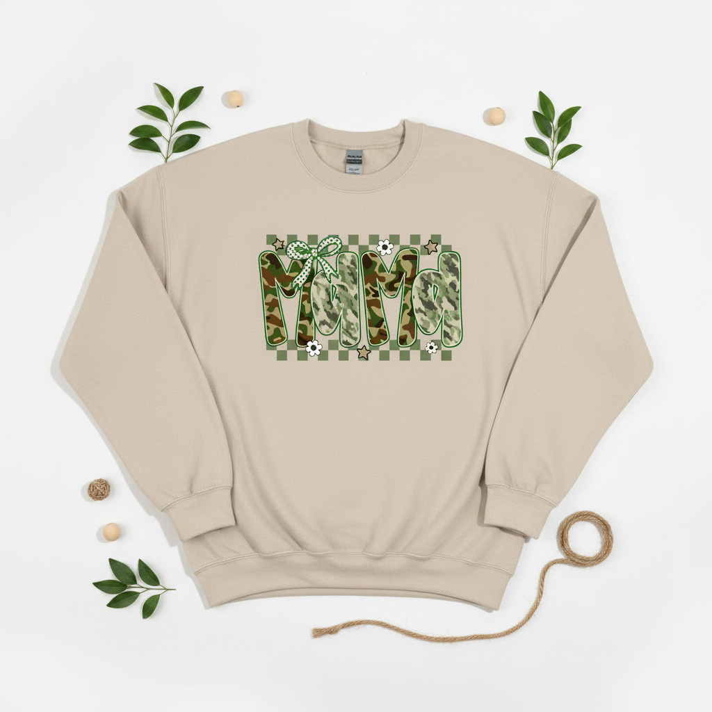 Flat lay of sand Mama camo checkered bow t-shirt on white background with green leaf props