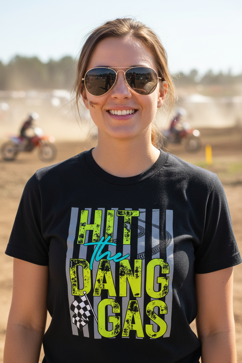 Woman wearing Hit the Dang Gas black tee at motocross event