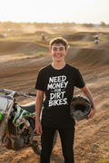 Cheeky kid wearing Need Money for Dirt Bikes black tee at motocross track