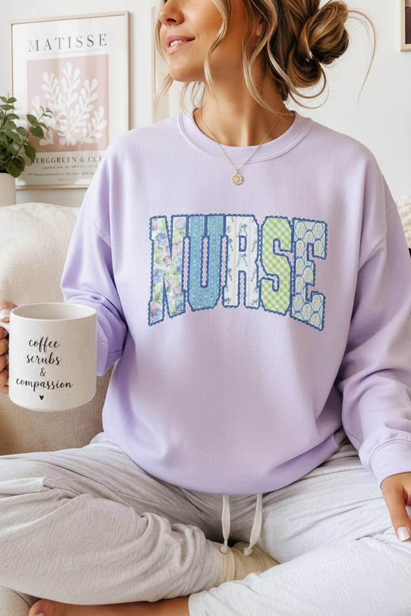 Woman wearing lavender oversized nurse patchwork graphic tee holding a coffee mug