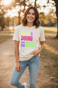 Woman wearing Bit of a Mess Doing My Best T-Shirt in ivory in a fun casual outdoor lifestyle photo