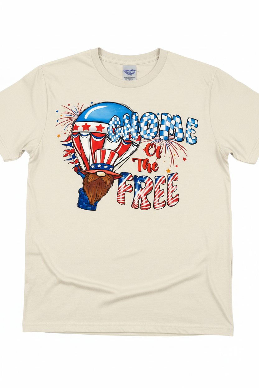 Gnome of the Free T-Shirt flat lay on natural ivory tee showing gnome in patriotic hot air balloon