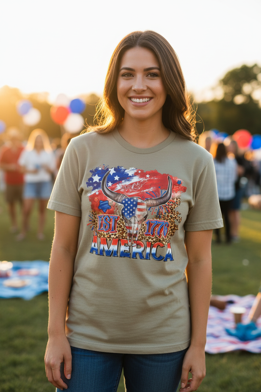 Woman wearing America EST 1776 Longhorn T-Shirt in sand khaki at a sunny 4th of July celebration