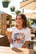 Woman holding iced coffee wearing Coffee Makes Me Happy retro graphic tee