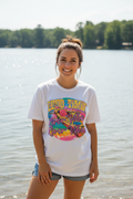 Woman wearing Good Timin' River Vibin' tee outdoors near water