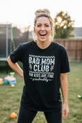 Woman wearing Bad Mom Club T-Shirt in black in a fun casual lifestyle photo
