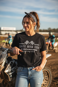 Woman wearing Race Mom Era graphic tee - lifestyle motocross setting