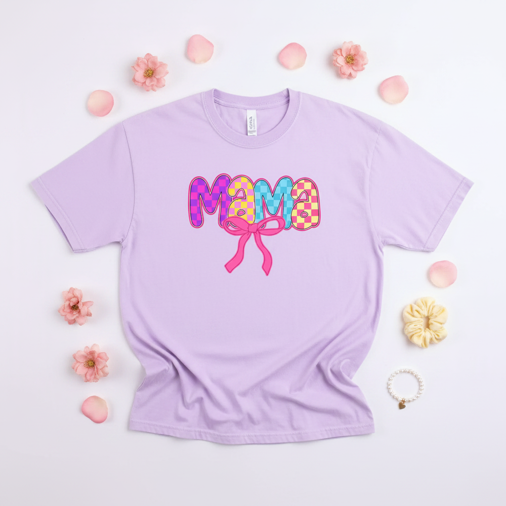 Flat lay of lavender Comfort Colors mama vibrant checkered bow tee on white background with pastel accessories