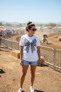 Woman wearing Race Day Mama checkered bow tee at outdoor motocross event