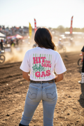 Woman wearing Hit the Dang Gas retro moto tee showing back print at motocross event