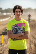 Person wearing neon yellow Moto Racing graphic tee at motocross track